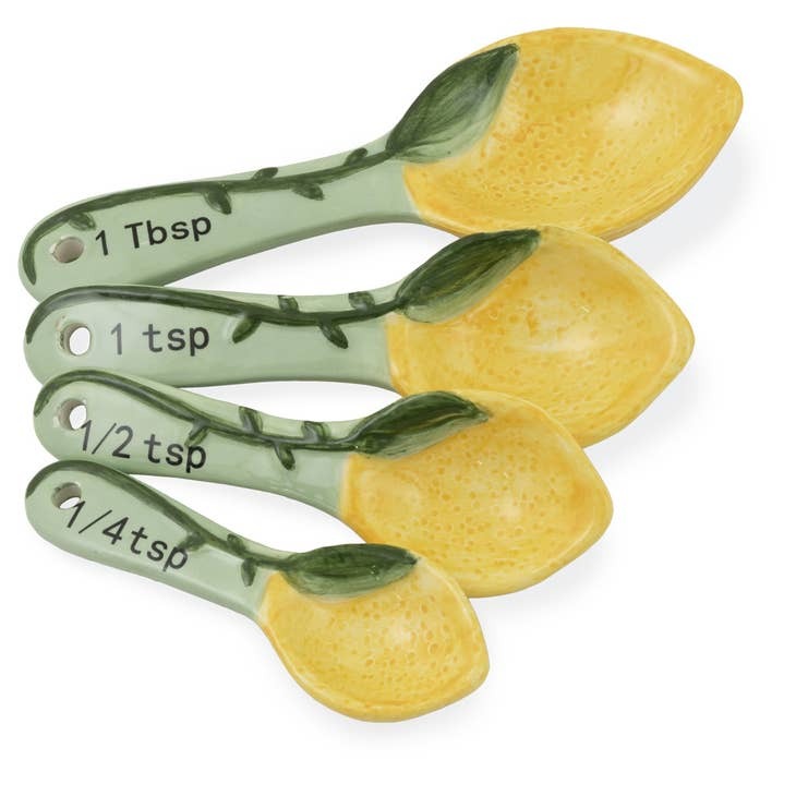 This is a picture of measuring spoons that are made to look like lemons with vines. There are four in the set, each with a different measuring amount.
