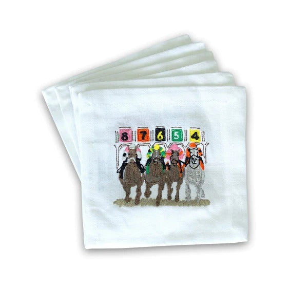 This is a set of small white cocktail napkins with a colorful embroidered scene of Kentucky Derby horses leaving the paddock at the start of a race. 